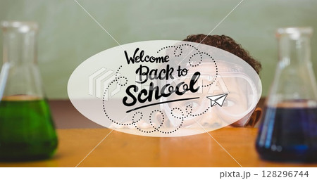 Image of back to school text over schoolboy and beakers 128296744