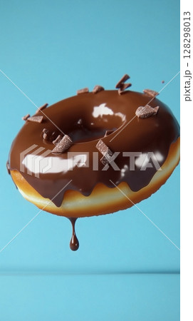 Sweet sprinkle of melted chocolate cream topping donut fries snack food flying for tea time 128298013