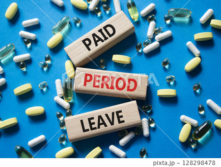 Paid Period Leave symbol. Concept words Paid Period Leave on wooden blocks. Beautiful blue background with pills. Healthcare and Paid Period Leave concept. Copy space. Paid Period Leave symbol. Concept words Paid Period Leave on wooden blocks. Beautiful blue background with pills. Healthcare and Paid Period Leave concept. Copy space. 128298478