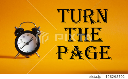 Turn the Page symbol. Concept words Turn the Page on Beautiful orange background with alarm clock. Business and Turn the Page concept. Copy space. Turn the Page symbol. Concept words Turn the Page on Beautiful orange background with alarm clock. Business and Turn the Page concept. Copy space. 128298502