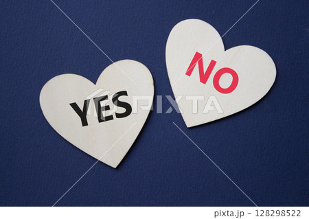 Yes or No symbol. Concept word Yes or No on wooden hearts. Beautiful deep blue background. Business and Yes or No concept. Copy space 128298522