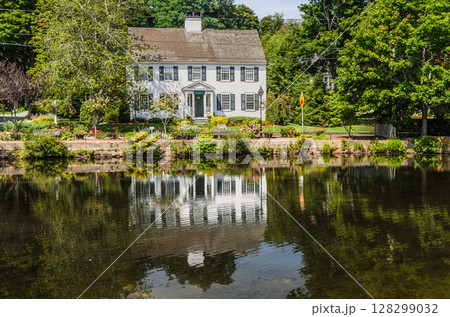 Historic New England house reflected in Shawme Lake, Sandwich, Massachusetts, USA 128299032