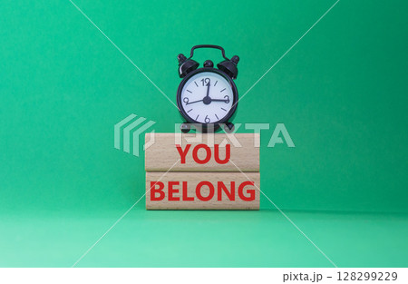 You belong symbol. Concept words You belong on wooden blocks. Beautiful green background with alarm clock. Business and You belong concept. Copy space. You belong symbol. Concept words You belong on wooden blocks. Beautiful green background with alarm clock. Business and You belong concept. Copy space. 128299229
