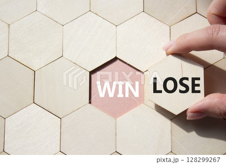 Win or Lose symbol. Concept word Win or Lose on wooden comb puzzle. Businessman hand. Beautiful pink background. Business and Win or Lose concept. Copy space 128299267