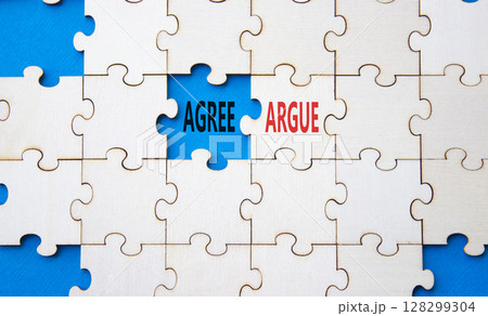 Agree or Argue symbol. Concept word Agree or Argue on wooden puzzle. Beautiful blue background. Business and Agree or Argue concept. Copy space Agree or Argue symbol. Concept word Agree or Argue on wooden puzzle. Beautiful blue background. Business and Agree or Argue concept. Copy space 128299304