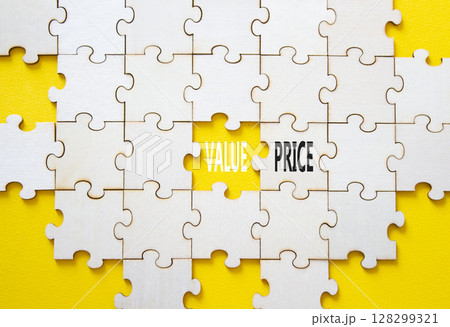 Price and Value symbol. Concept word Price and Value on wooden puzzle. Beautiful yellow background. Business and Price and Value concept. Copy space 128299321