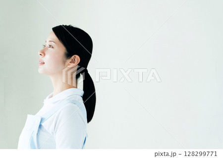 エプロン姿の若い女性 128299771