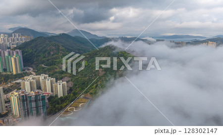 March 2 2025 View of Urban Skyline Meeting Green Hills and Dense Clouds March 2 2025 View of Urban Skyline Meeting Green Hills and Dense Clouds 128302147