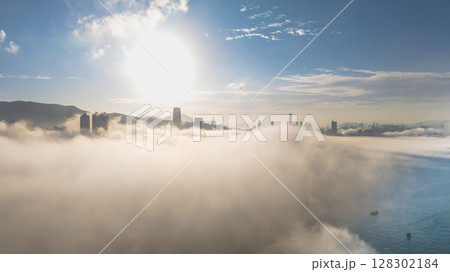 March 2 2025 Urban Skyline Emerging Through Clouds During sunset 128302184