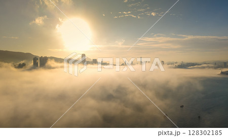 March 2 2025 Urban Skyline Emerging Through Clouds During sunset 128302185
