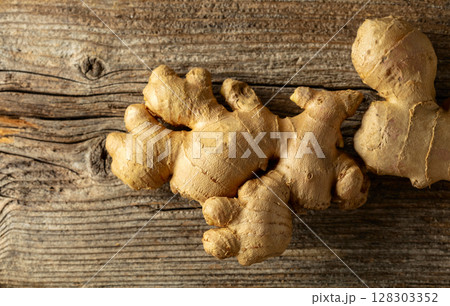 Ginger on a old wooden board. 128303352