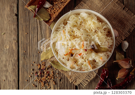 Traditional German sauerkraut on a old rustic wooden table. Traditional German sauerkraut on a old rustic wooden table. 128303370
