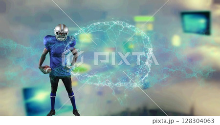 Image of digital brain spinning over male american football player holding ball Image of digital brain spinning over male american football player holding ball 128304063