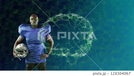 Image of digital brain spinning over male american football player holding helmet Image of digital brain spinning over male american football player holding helmet 128304067