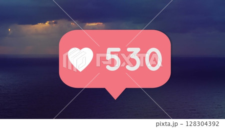 Digital image of heart icon with number text over sky and sea background Digital image of heart icon with number text over sky and sea background 128304392