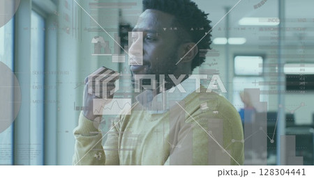 Image of financial data processing over businessman thinking in office 128304441