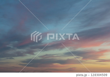 Colorful twilight sky filled with clouds at sunset above a serene landscape capturing a moment of tranquility and beauty Colorful twilight sky filled with clouds at sunset above a serene landscape capturing a moment of tranquility and beauty 128304509
