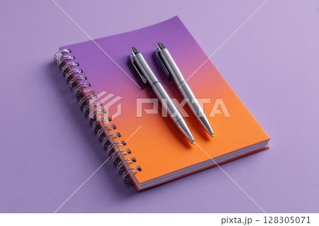 notebook with two silver pens 128305071