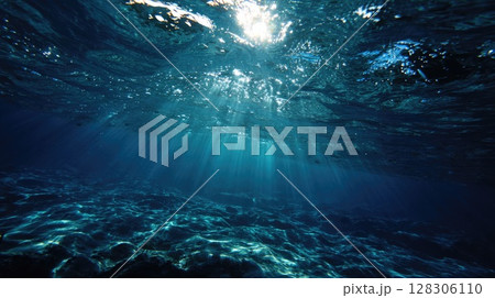 serene underwater scene with the sun's rays piercing through the ocean surface 128306110