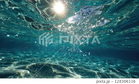 serene underwater scene with the sun's rays piercing through the ocean surface serene underwater scene with the sun's rays piercing through the ocean surface 128306116