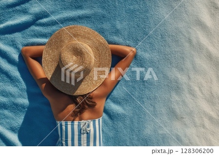 top view of a woman sunbathing on the beach 128306200