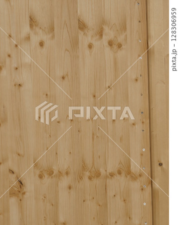 A wooden surface with a grain pattern and a few holes A wooden surface with a grain pattern and a few holes 128306959