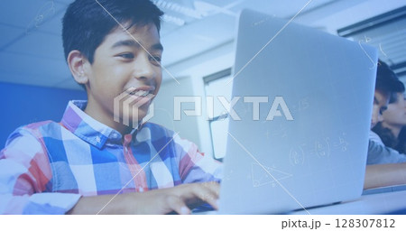 Image of mathematical equations over schoolchildren using laptop 128307812