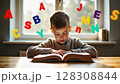 A young boy is engrossed in reading a book at a table, with colorful alphabet letters floating around him, symbolizing learning. - Generic AI Image 128308844