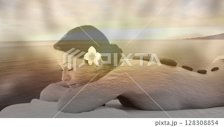 Digital composite of woman enjoying a relaxing back massage, with relaxing view of the sea at sunset 128308854