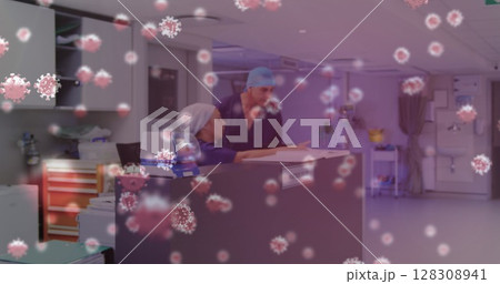 Healthcare workers in hospital discussing patient records amid virus outbreak 128308941