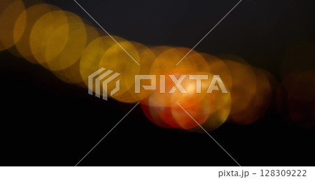 Image of multiple flickering yellow spots of light on black background Image of multiple flickering yellow spots of light on black background 128309222