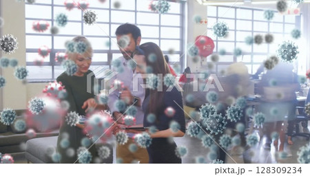 Image of covid 19 cells over people working in busy office Image of covid 19 cells over people working in busy office 128309234