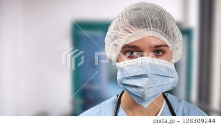 Portrait of female caucasian surgeon wearing face mask surgical cap in hospital Portrait of female caucasian surgeon wearing face mask surgical cap in hospital 128309244