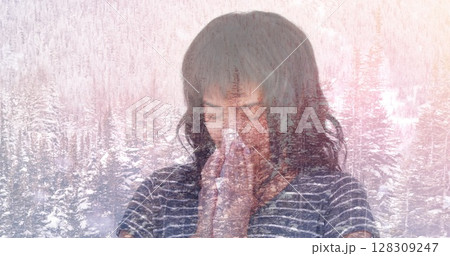 Image of woman blowing her nose against winter scenery Image of woman blowing her nose against winter scenery 128309247