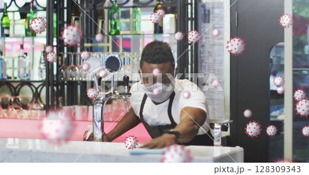 Image of covid-19 cells floating over african american man disinfecting a bar Image of covid-19 cells floating over african american man disinfecting a bar 128309343
