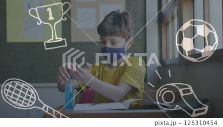 Image of school icons over schoolboy in face mask using hand sanitizer 128310454