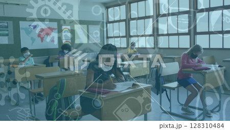 Multiple covid 19 icons floating against group of students wearing face masks studying at school Multiple covid 19 icons floating against group of students wearing face masks studying at school 128310484