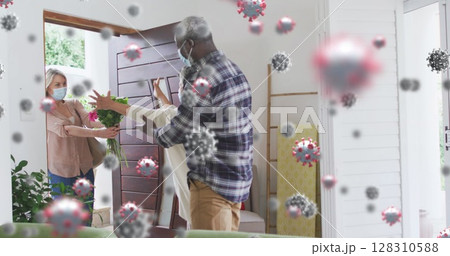 Multiple covid-19 cells floating against african american couple welcoming caucasian couple at home Multiple covid-19 cells floating against african american couple welcoming caucasian couple at home 128310588