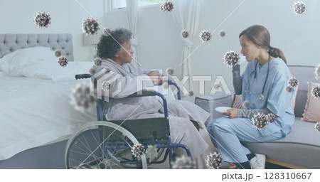 Image of covid 19 cells floating over nurse with female patient having tea in hospital 128310667