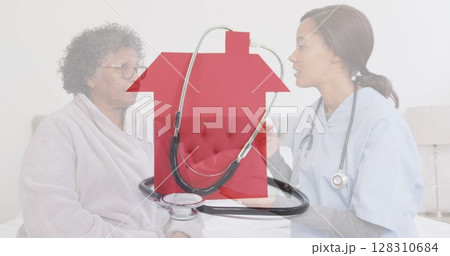 Image of stethoscope on red house over female doctor with senior woman talking Image of stethoscope on red house over female doctor with senior woman talking 128310684