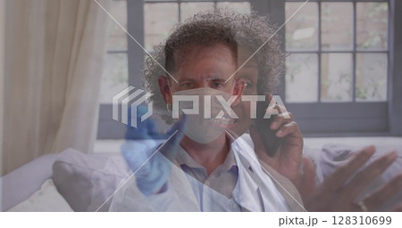 Image of male doctor holding test tube over senior woman talking on smartphone Image of male doctor holding test tube over senior woman talking on smartphone 128310699