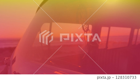 Image of dream catcher moving in camper van with yellow to red hue with sunset in background Image of dream catcher moving in camper van with yellow to red hue with sunset in background 128310733