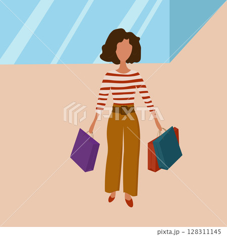 Beautiful girl on a shopping trip with bags in her hands. 128311145