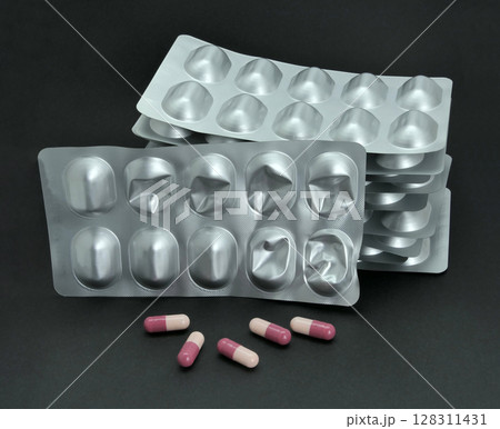 Tablet capsule blister on black background 128311431