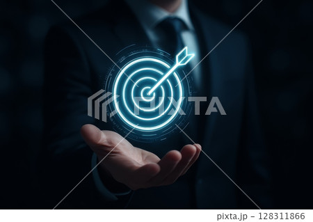 Businessman holding digital target with arrow in hand, symbolizing goal achievement and business strategy 128311866
