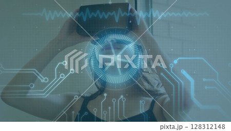 Image of scope scanning and data processing over woman wearing vr headset Image of scope scanning and data processing over woman wearing vr headset 128312148