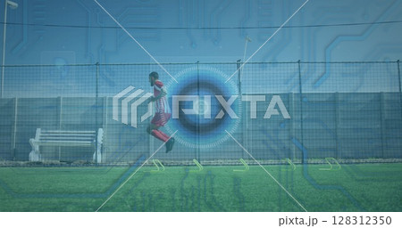 Microprocessor connections and round scanner against male soccer player practicing on grass turf Microprocessor connections and round scanner against male soccer player practicing on grass turf 128312350
