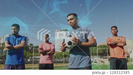 Network of connections against team of male soccer players standing on grass field Network of connections against team of male soccer players standing on grass field 128312385
