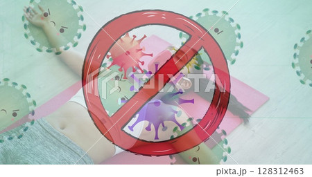Stop sign over covid-19 cells moving against woman wearing face mask lying on yoga mat at the gym 128312463