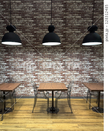Comfortable library setting with wooden tables and modern chairs against a brick wall Comfortable library setting with wooden tables and modern chairs against a brick wall 128312485